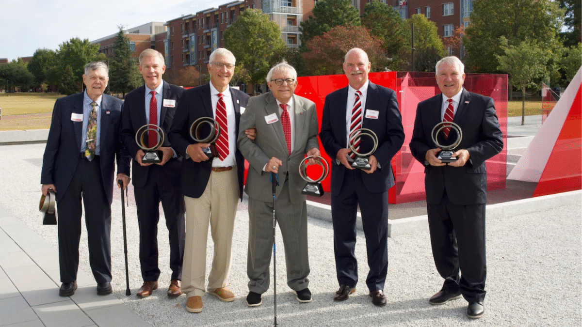 2024 Hall of Fame inductees standing outside HUnt Library holding awards